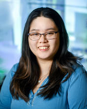 Young Asian woman with glasses and a blue shirt
