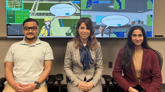 Shima and team with game graphics